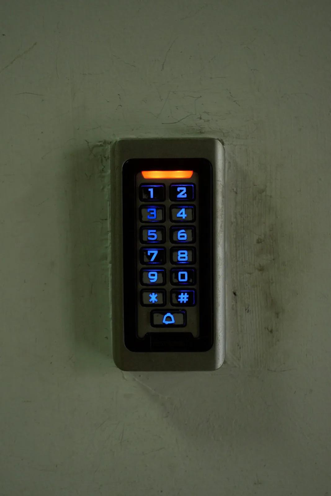 Backlit PIN access keypad mounted beside a door